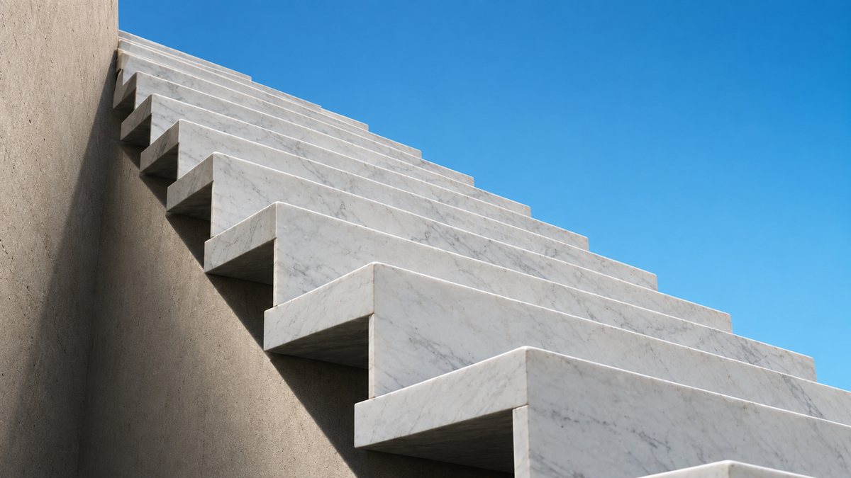 Marble staircase ascending toward blue sky